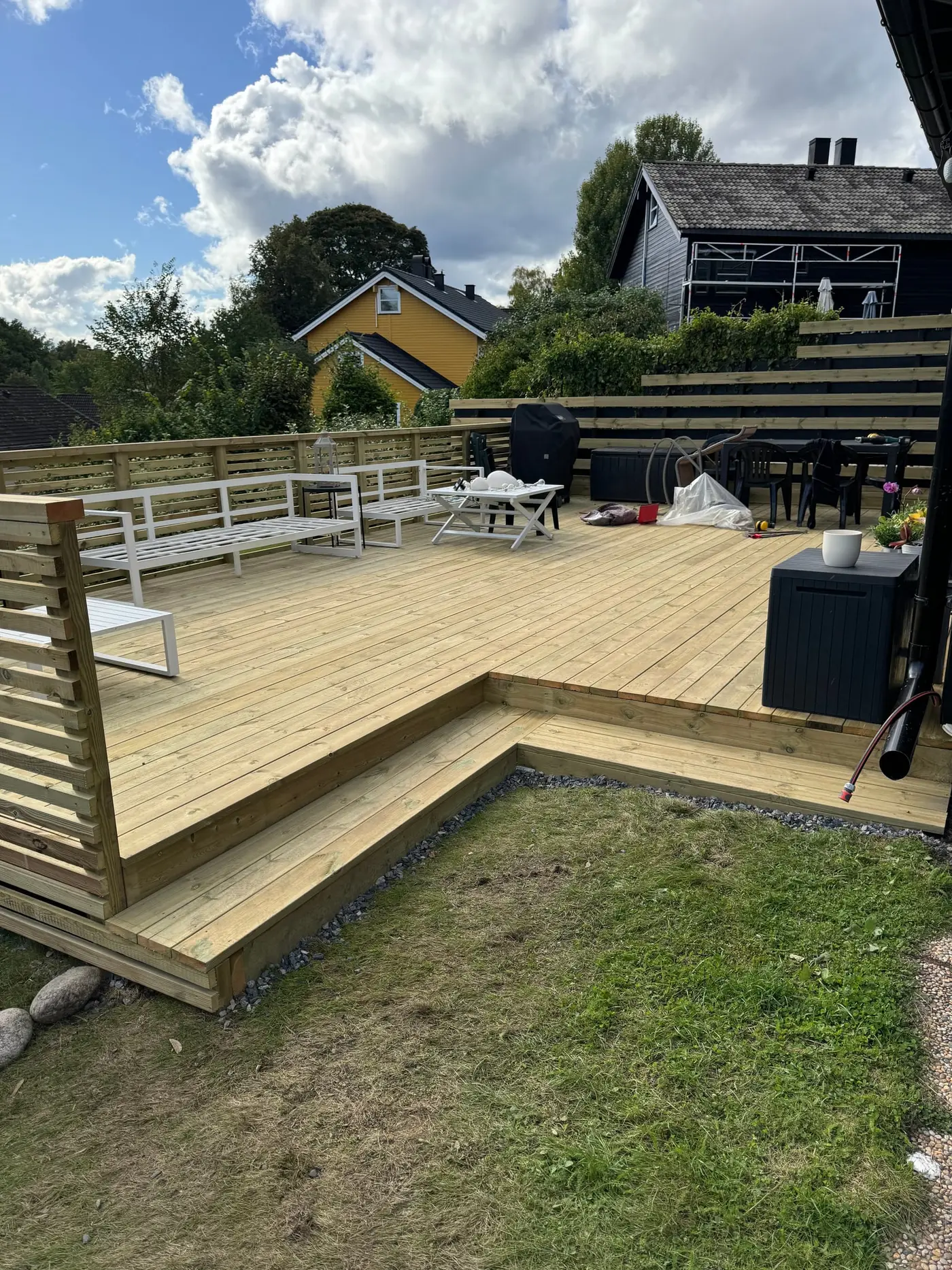 Stor ny terrasse i lyst impregnert tre med trinn og spilerekkverk
